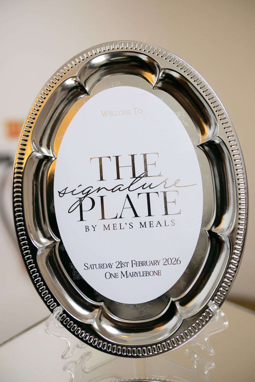 Elegant silver platter display sign for The Signature Plate by Mel's Meals event at One Marylebone, February 2026.