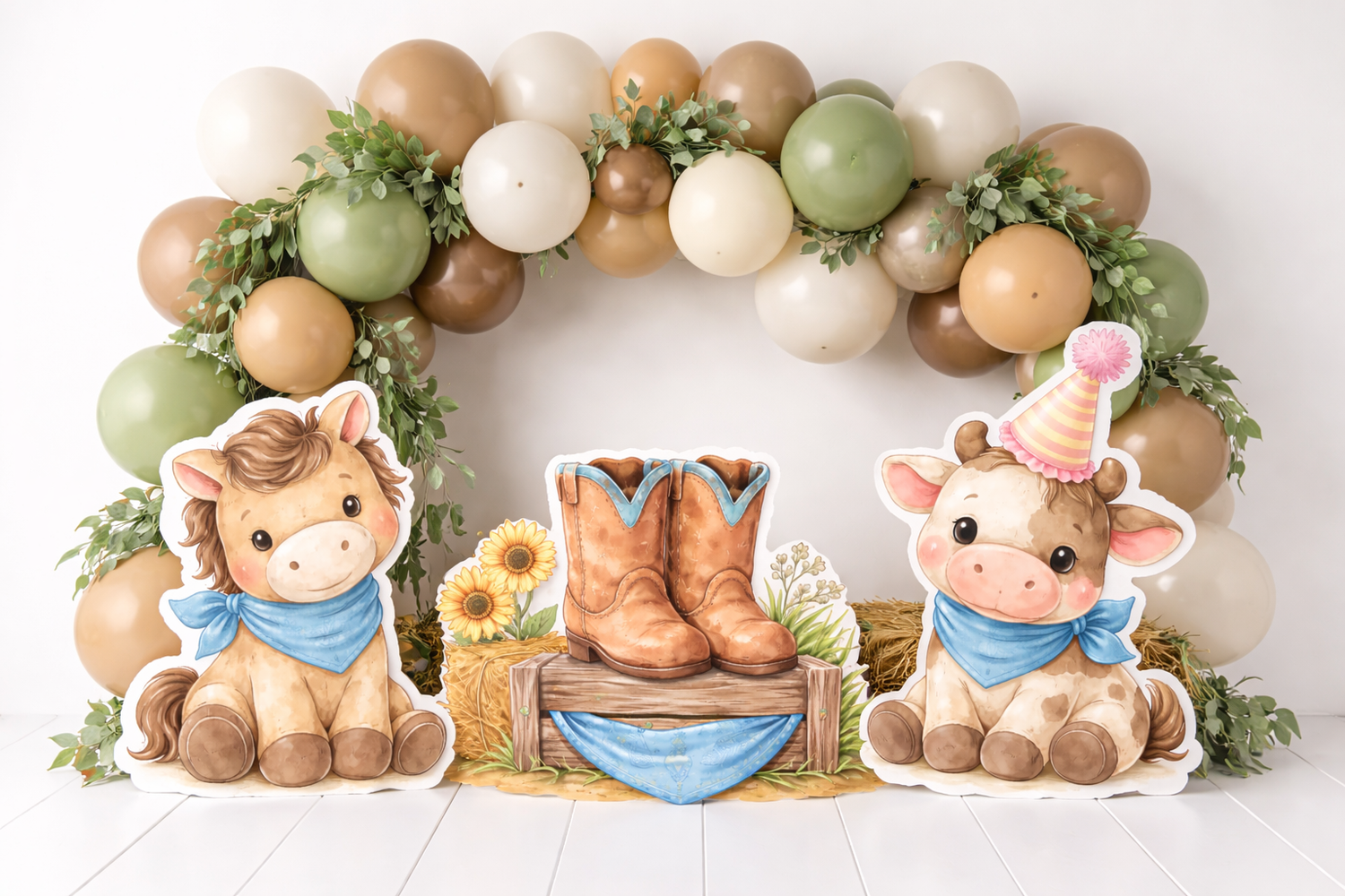 Cute farm animal cutouts with cowboy boots centerpiece and balloon arch for a western birthday party.Elizabeth Lang