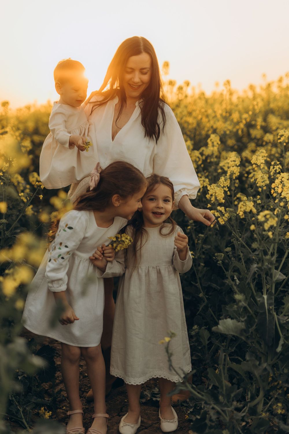 Outdoor family photography session in rapeseed field near Brussels