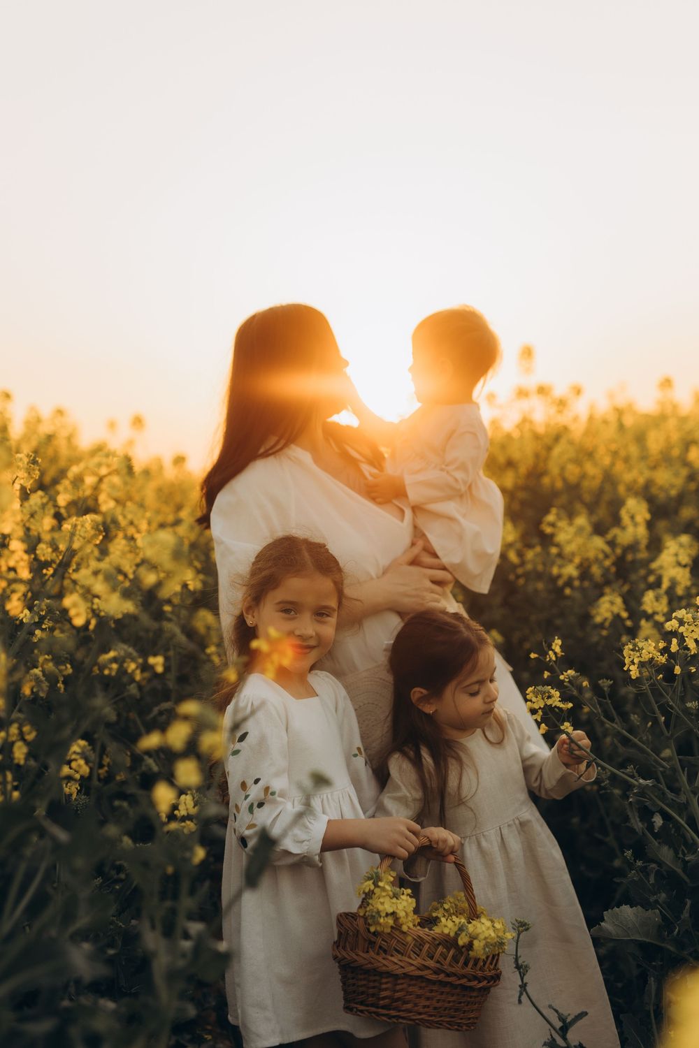 Outdoor family photography session in rapeseed field near Brussels
