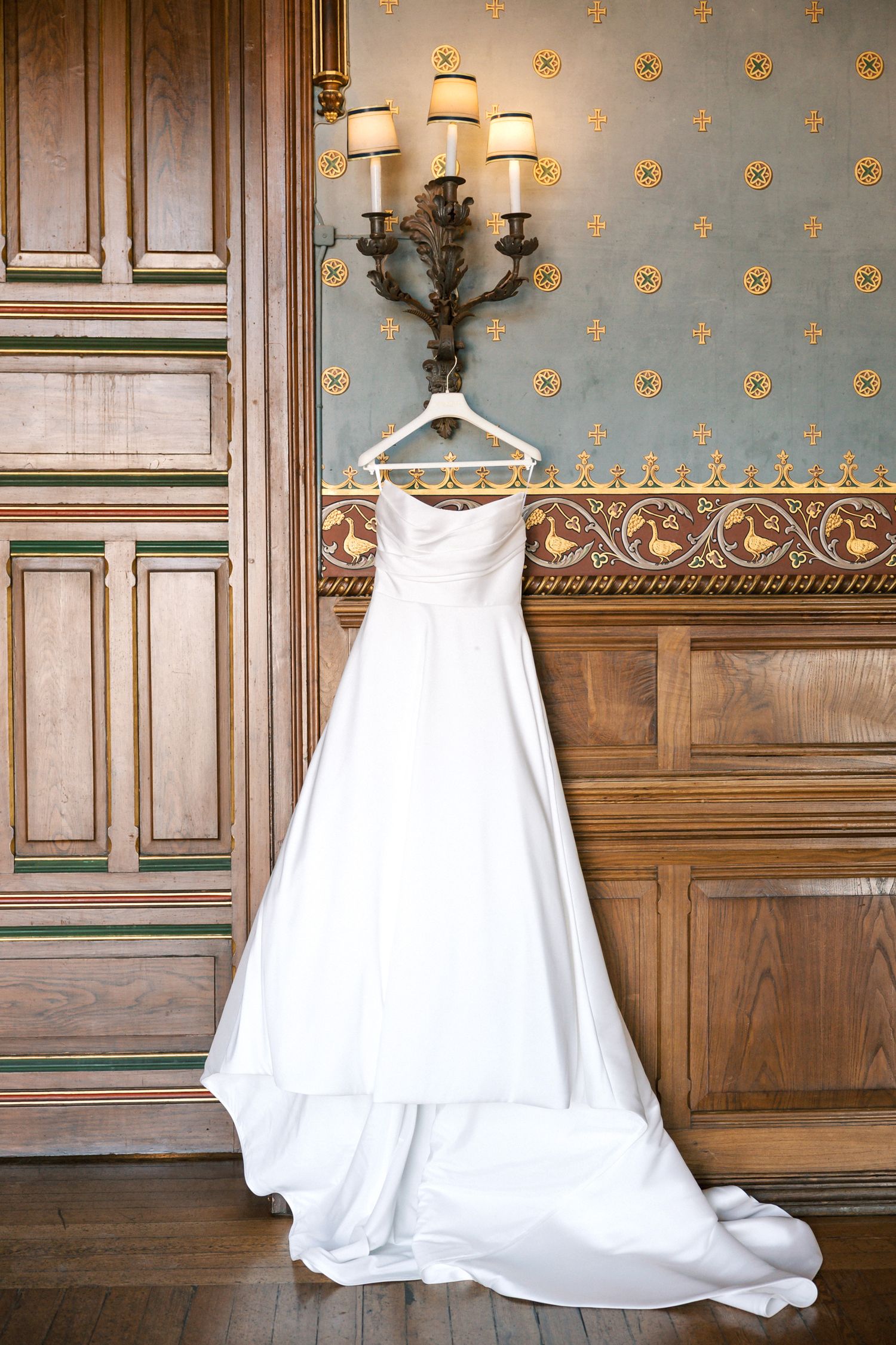 Bride wedding dress hanging at forte da cruz wedding venue before ceremony in Cascais Portugal