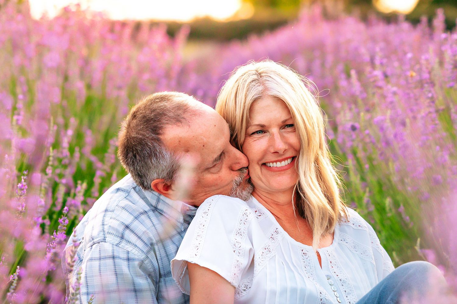 Photographer captures a stunning portrait of a couple in a lavender field at sunset near Clovis, CA.