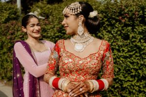 Festive wedding celebration scene with traditional South Asian bridal attire and jewelry.