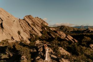 Dramatic angled rock formations in a mountainous landscape under blue skies.