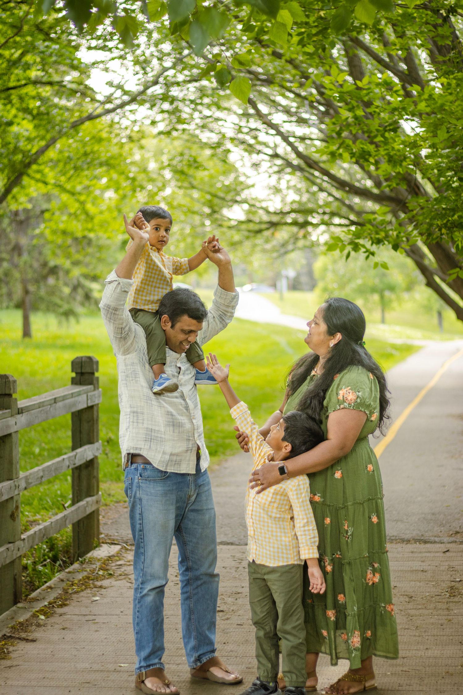 Family photo of 4 in a park
