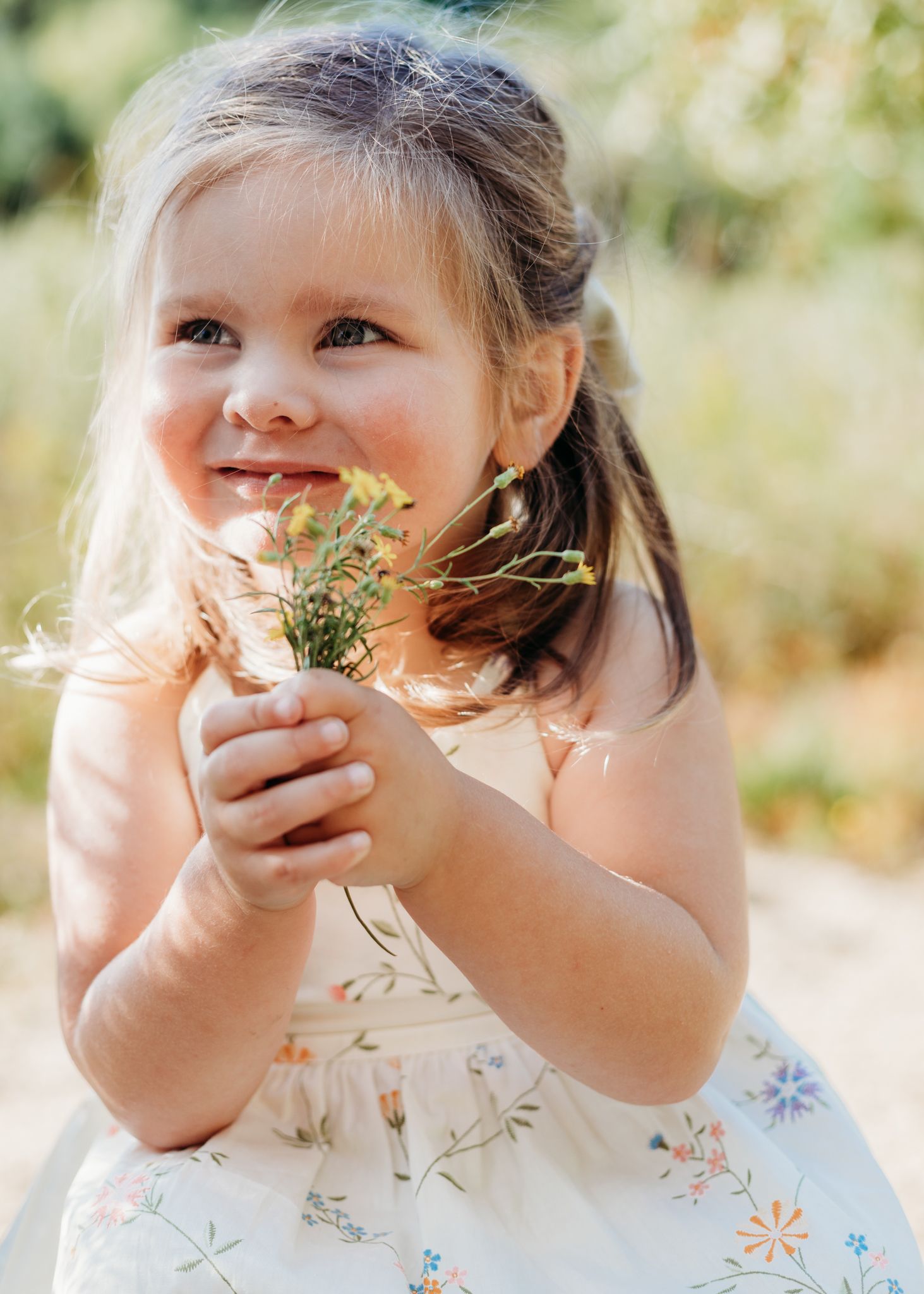 girl holding wildflowers
