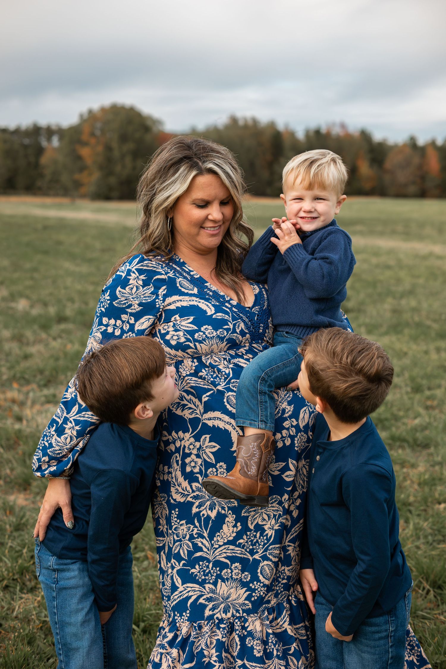 family walking across grass field for a family photo session