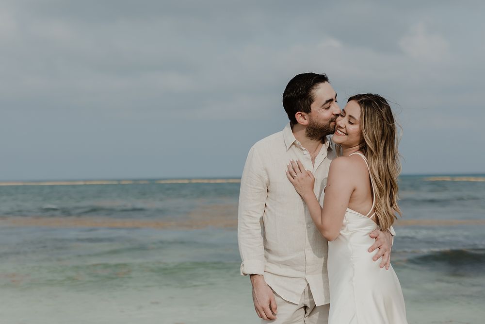Romantic embrace by the ocean during an engagement photoshoot in Playa del Carmen.