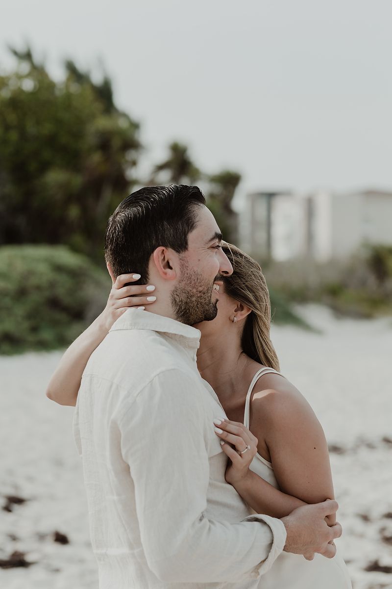 Couple sharing an intimate moment during a luxury engagement photoshoot in the Riviera Maya.