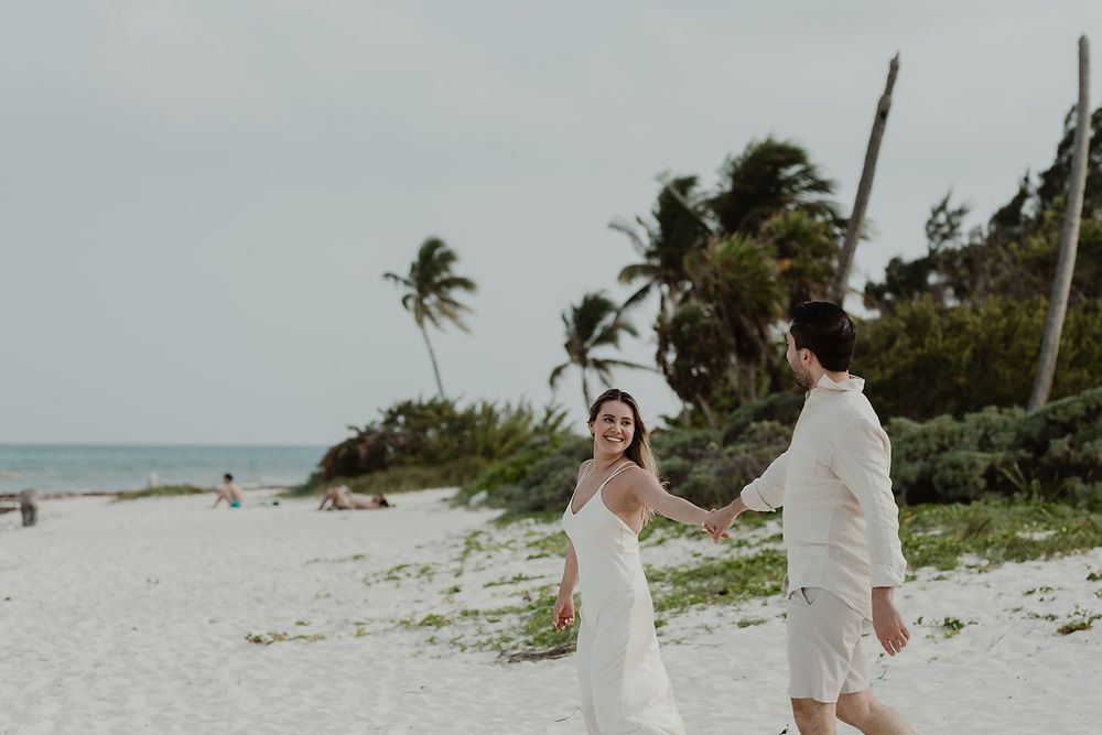 Couple sharing an intimate moment during a luxury engagement photoshoot in the Riviera Maya.