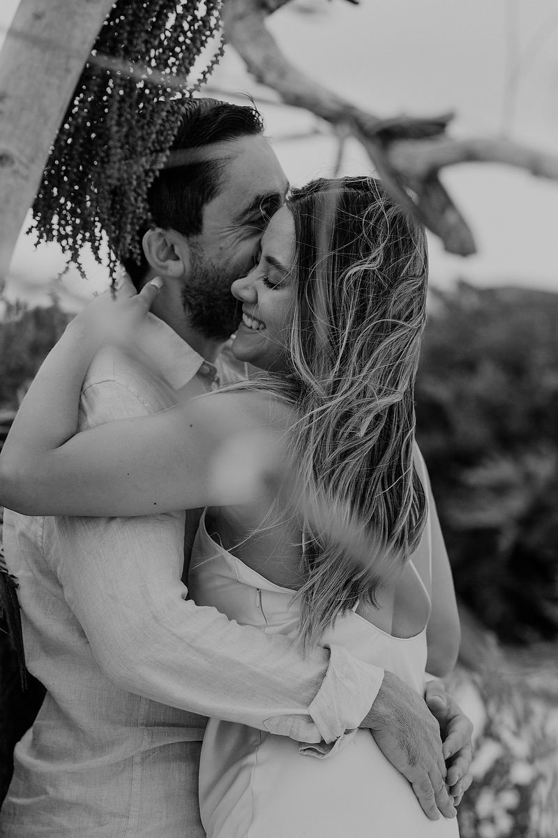 Black and white editorial engagement portrait surrounded by tropical jungle in Playa del Carmen.