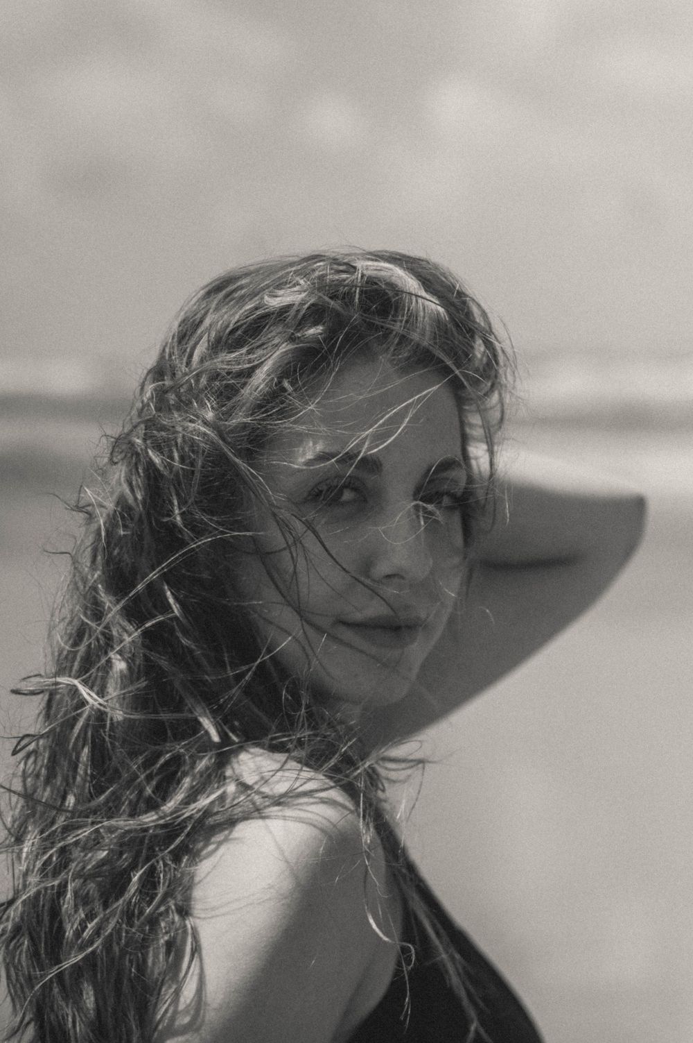 Profile view sequence showing windswept hair against bright sky in vintage style.