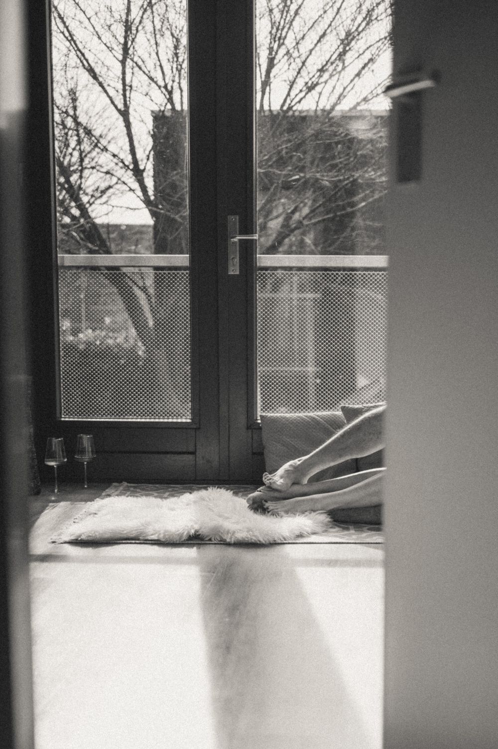 Minimalist interior scene with windows casting shadows on windowsill.