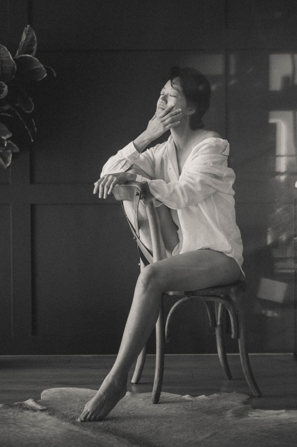 Dramatic black and white photo series of a person seated in an expressive pose on a chair.