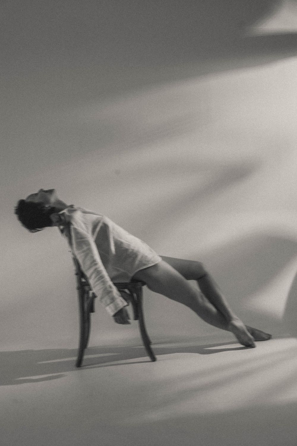 Black and white sequence showing a figure in flowing motion against a light background.