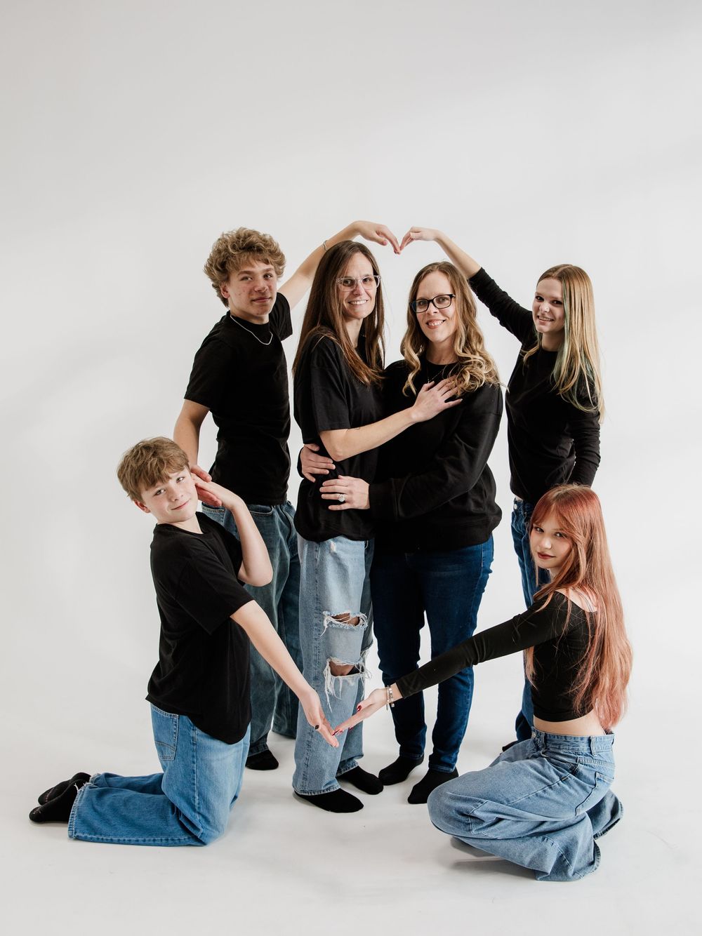 Casual group portrait series showing interactive poses against white studio background.