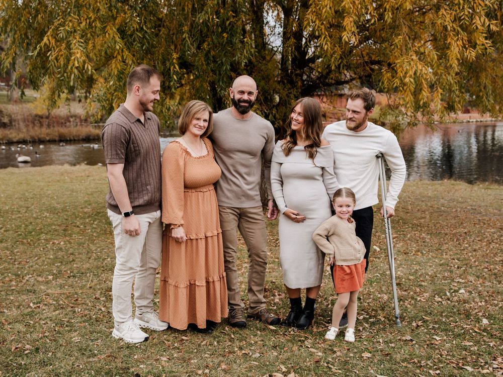 Fall family portrait series with coordinated neutral and rust-colored outfits among autumn leaves.