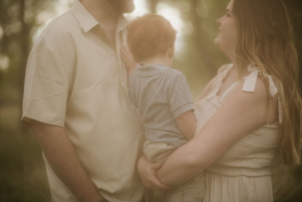 Intimate family moment captured in soft golden lighting.