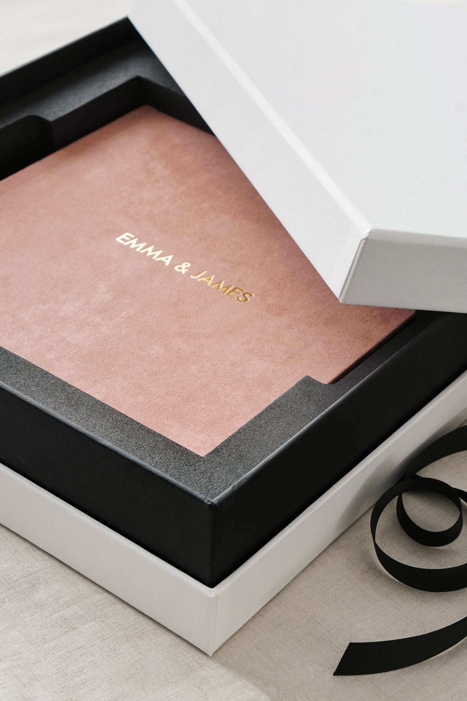 A series of high-end business cards with minimalist black and copper-rose metallic design showing fine textured details.