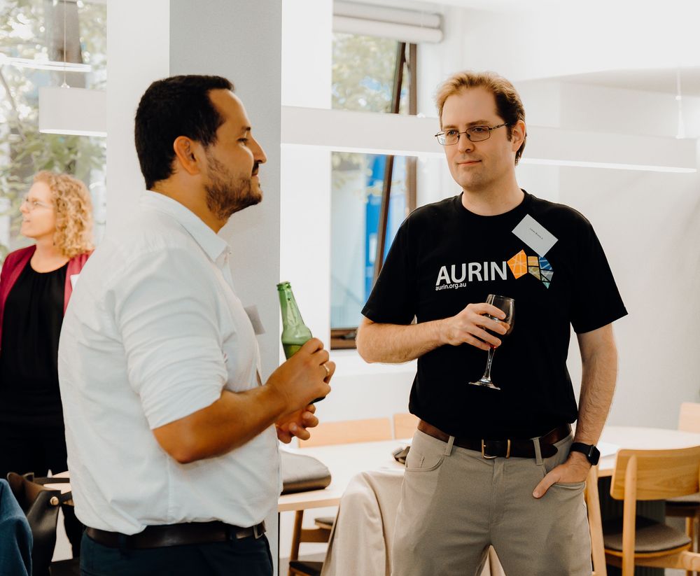 Informal business meeting setting with people collaborating in a modern office workspace.