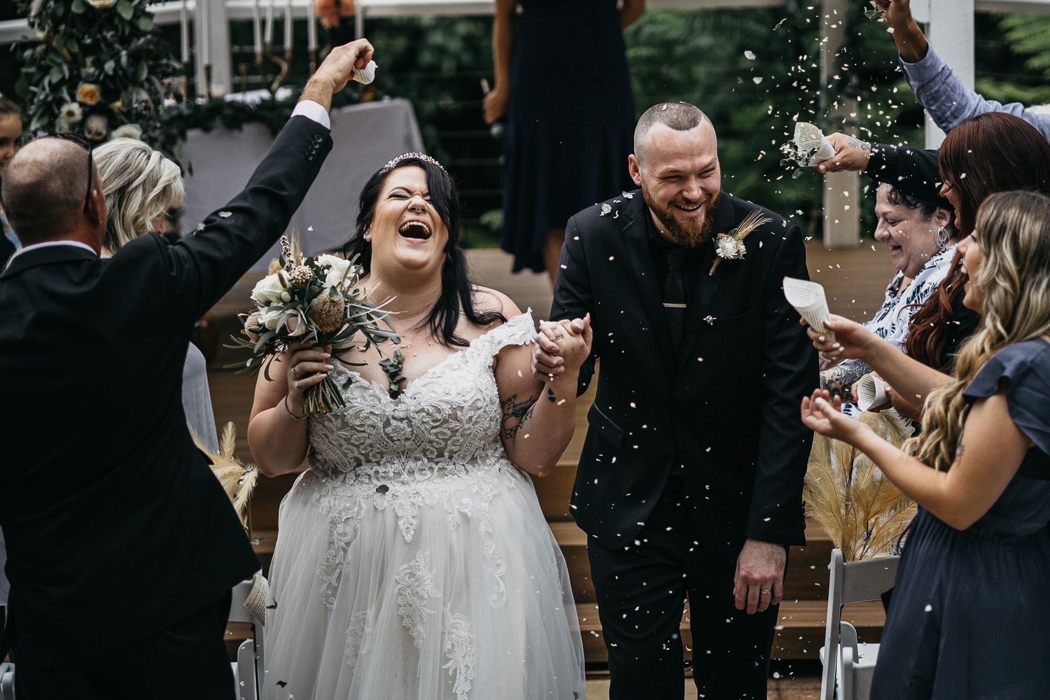 Beautiful bride and groom walking down the isle with joy and excitment
