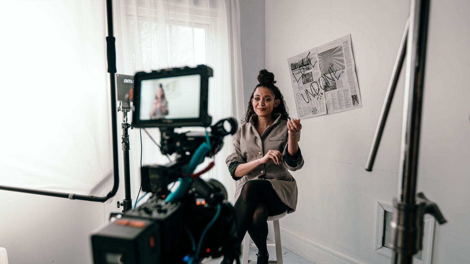 Behind-the-scenes studio setup with camera equipment and lighting gear for professional video production.