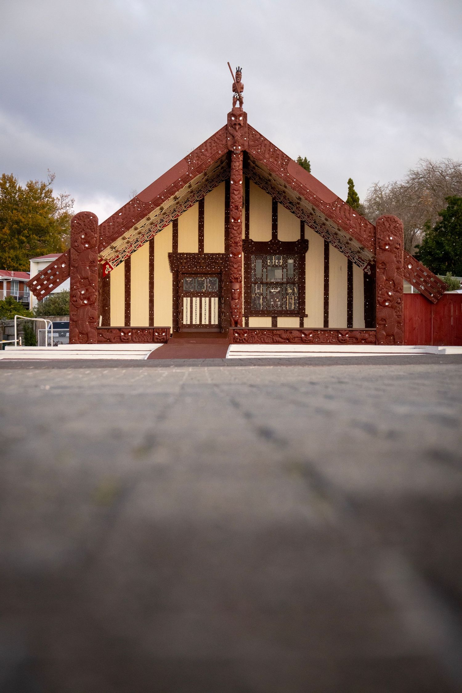 Close-up of a traditional Māori meeting house with intricate carvings.