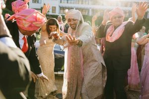 Festive celebration scene with people dancing and enjoying themselves in colorful traditional attire.