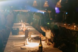 Atmospheric evening reception with candlelit tables and moody lighting.