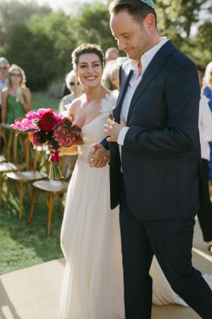 Wedding celebration moment captured outdoors with bright natural lighting.