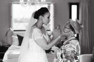 Emotional black and white moment captured during wedding preparations.