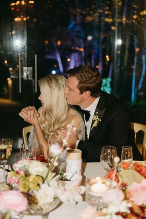 Romantic dinner scene with elegant table settings and soft candlelight.