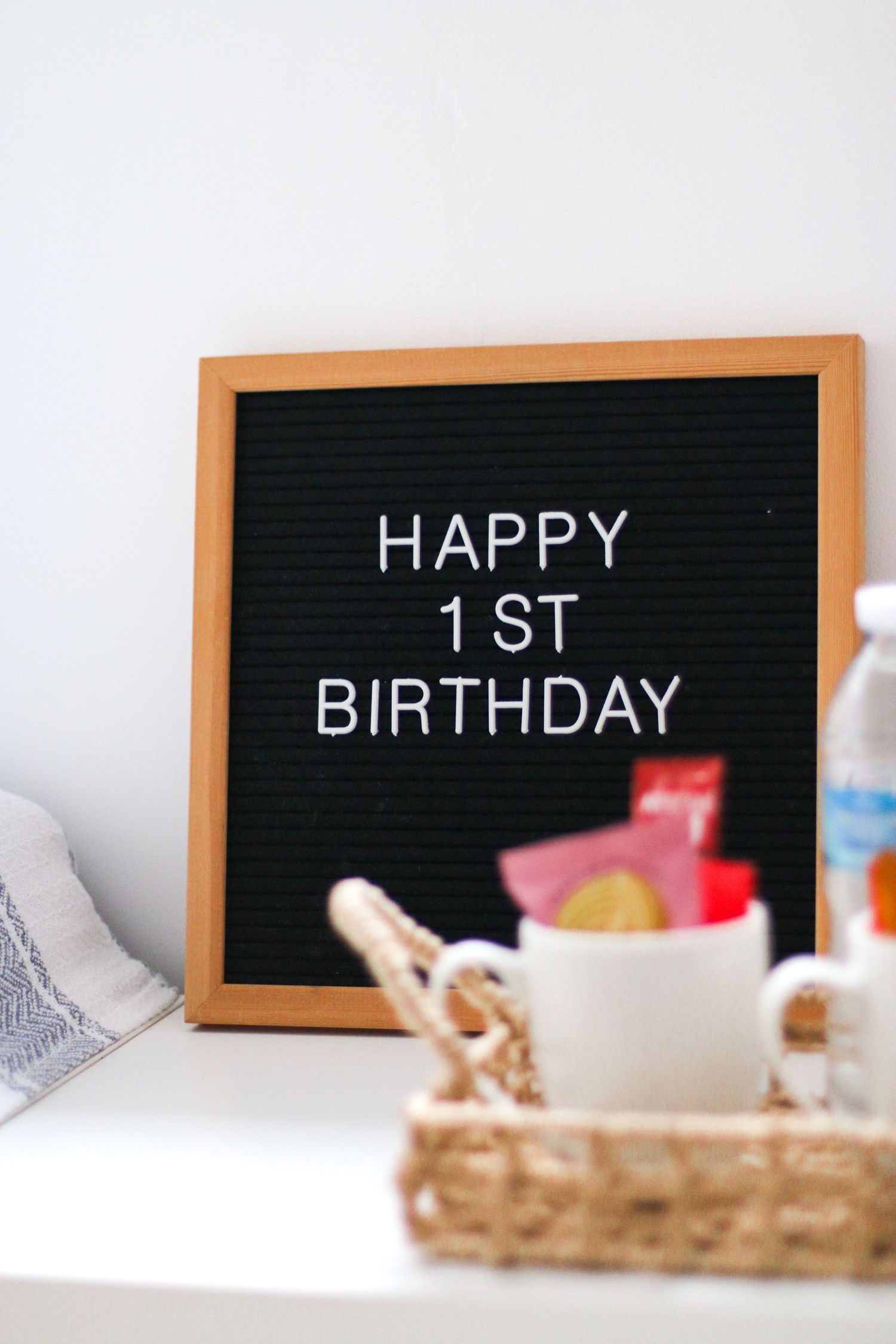 A black letter board with text displayed in white letters, with a woven basket in soft focus below, Nottingham photography studio