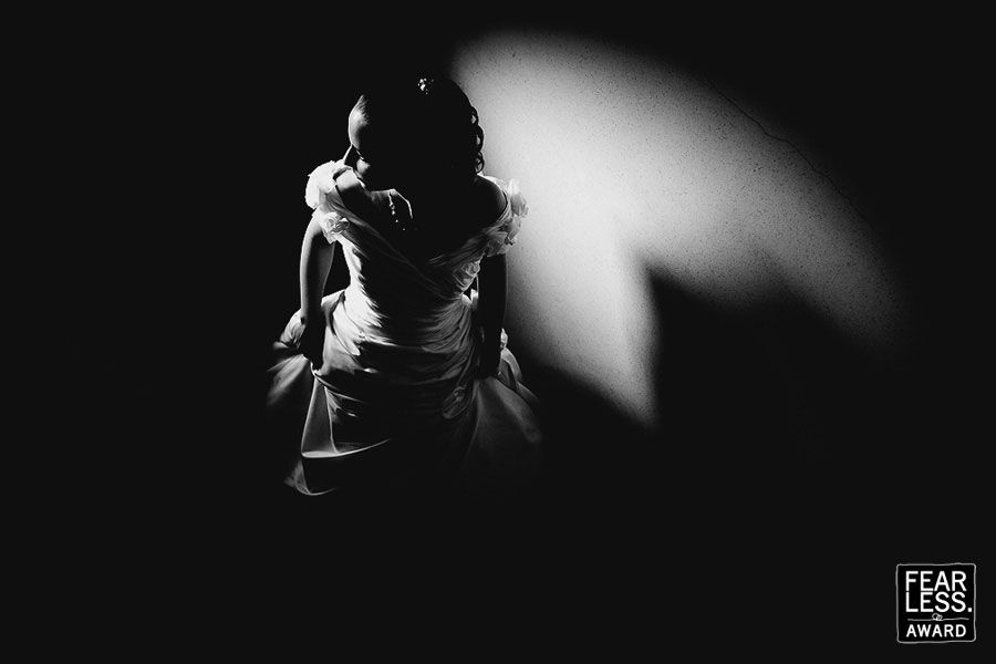 Dramatic black and white silhouette of a person in backlit lighting creating strong shadows and contrast.