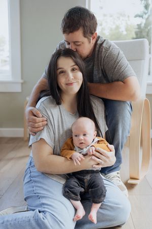 new parents holding their baby boy in-home lifestyle photography sessions in Moncton New Brunswick family photographer