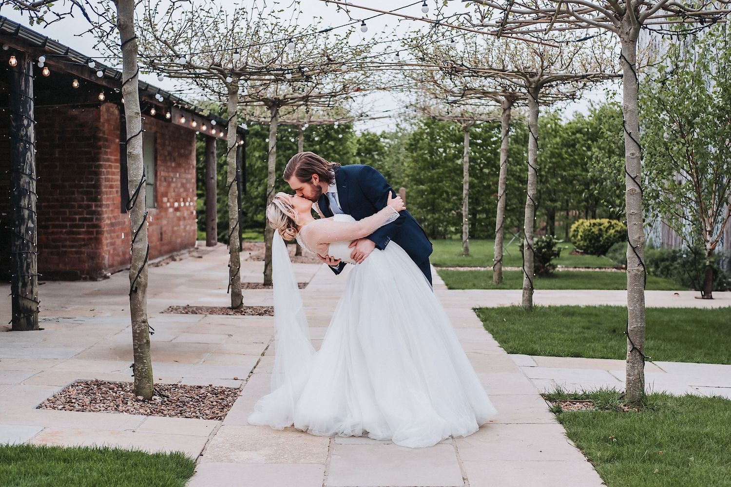 Elegant wedding bouquets featuring blush roses and greenery alongside formal attire.