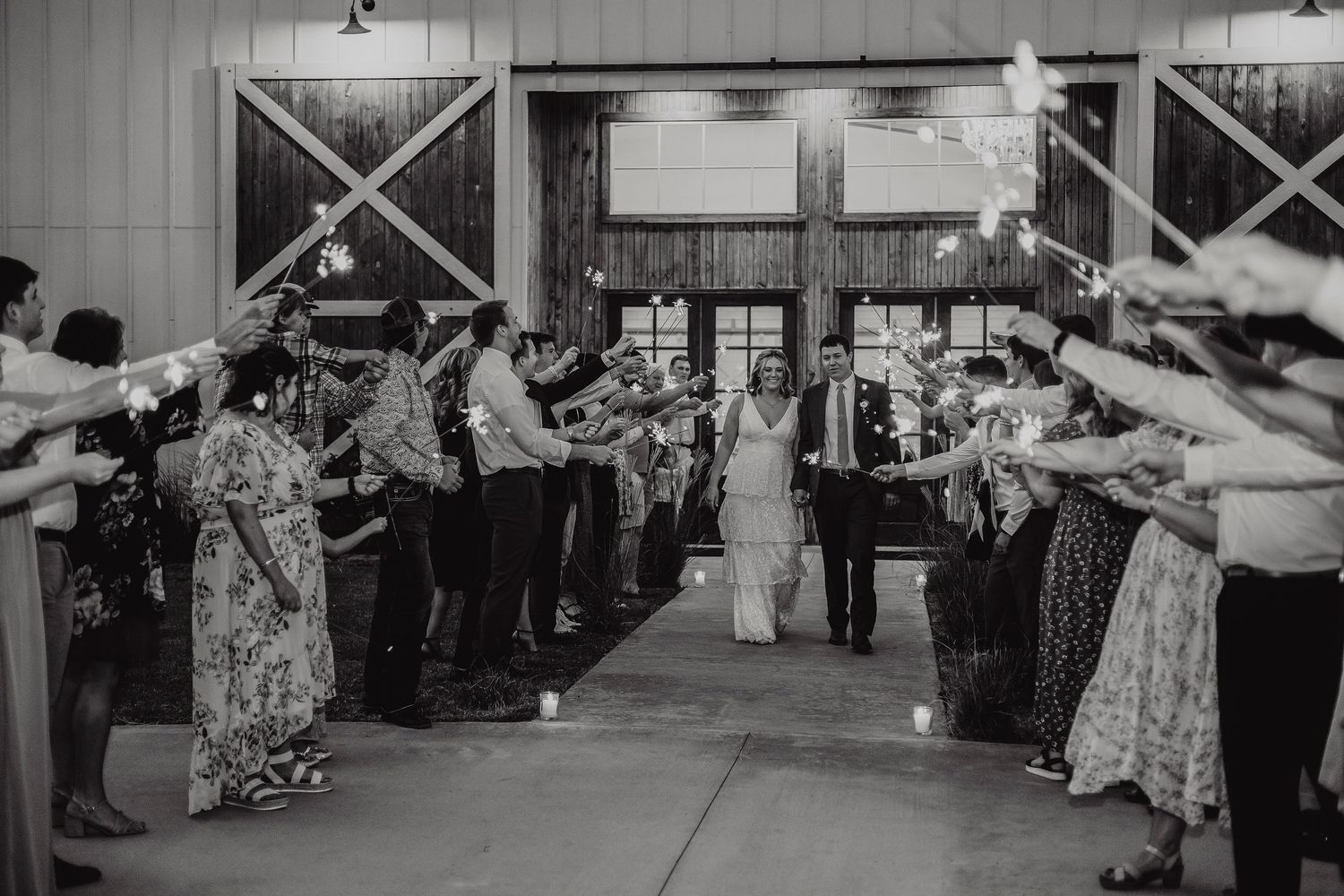 Black and white photo of a crowded indoor event space with people mingling.