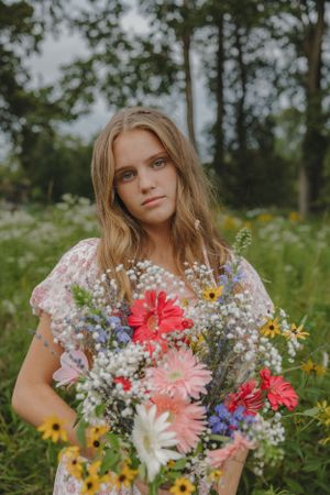 Summer portrait with colorful wildflower bouquet featuring gerbera daisies.