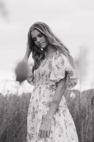 Black and white portraits showing a dreamy floral dress in a natural outdoor setting.