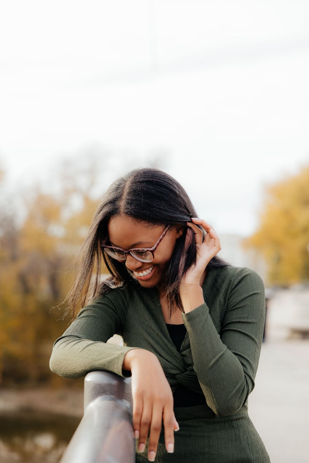 Candid shots of laughter and joy while posing on an outdoor bridge.