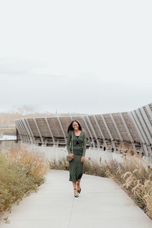 Walking shots along a curved pathway with architectural features in the background.