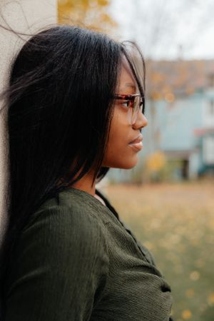 Profile portraits against a soft autumn background in olive green attire.