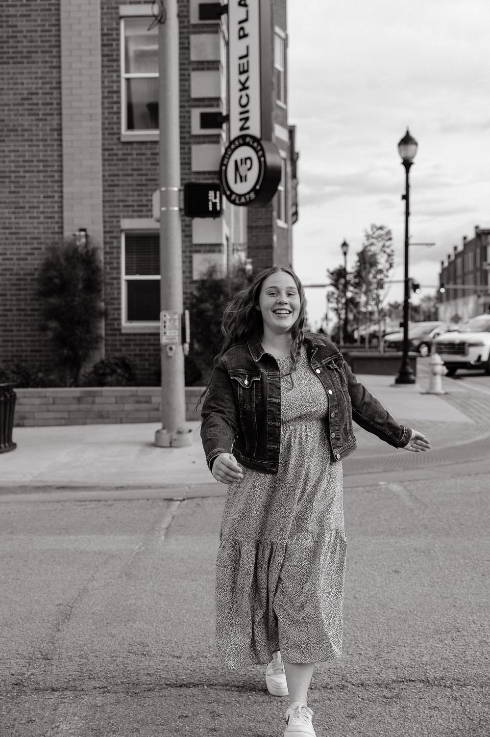 Black and white street photography showing movement and joy in an urban setting.