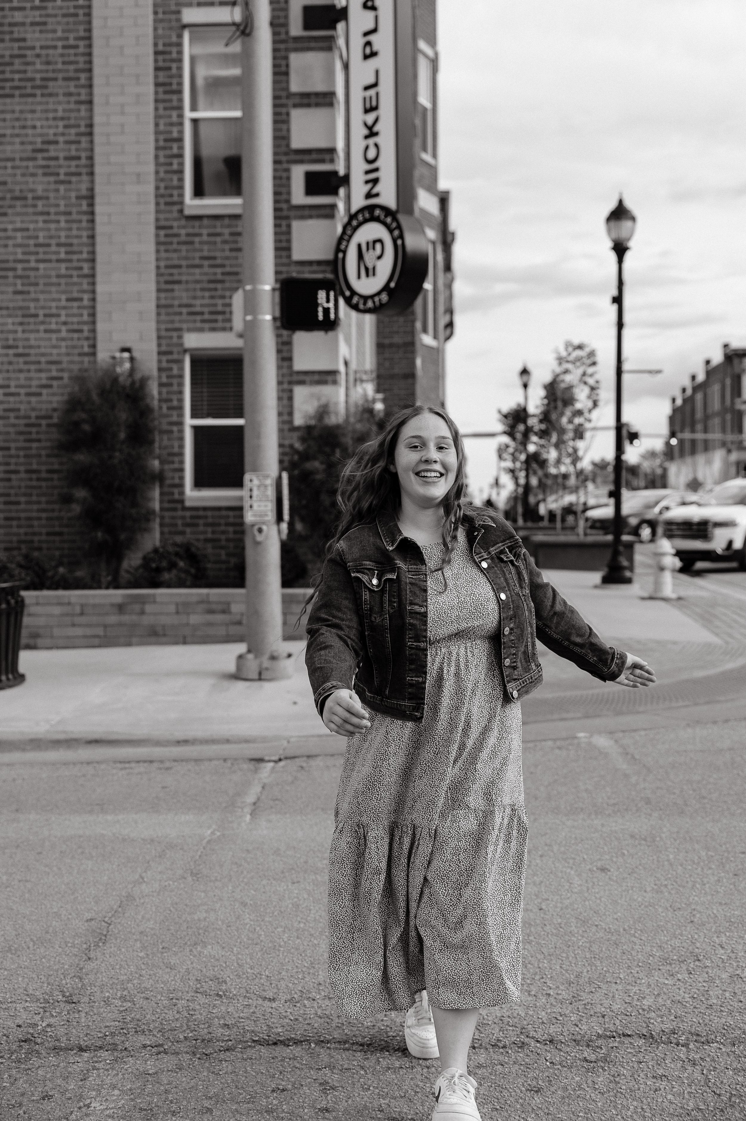Black and white street photography showing movement and joy in an urban setting.