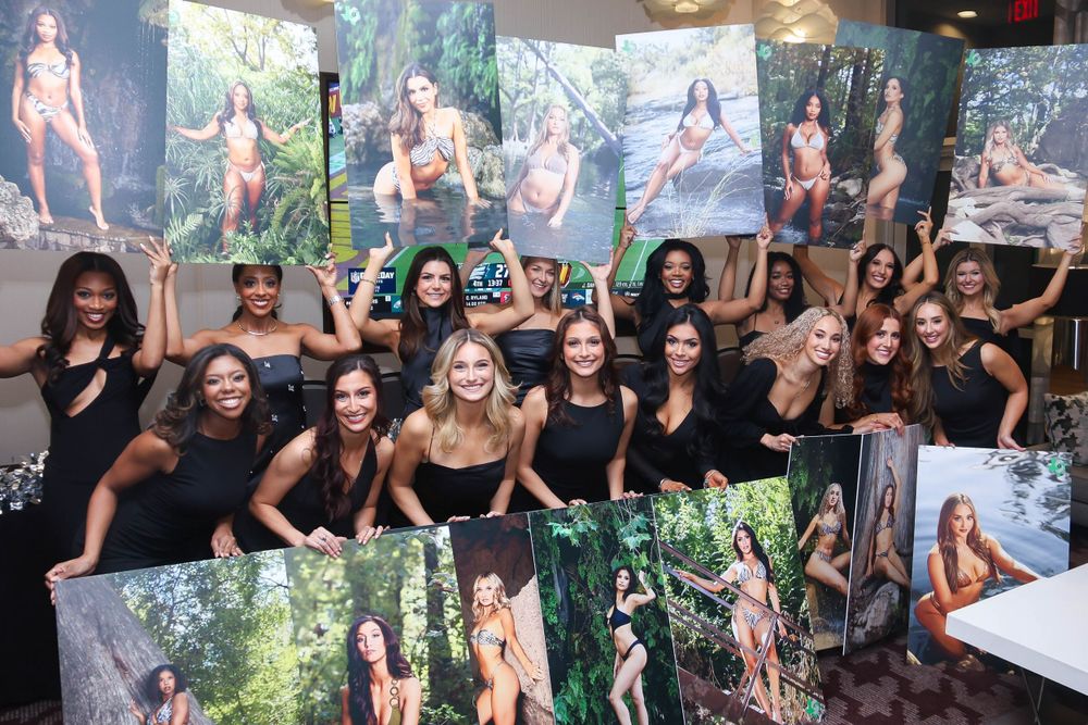 Large group photo of people gathered at a social event with greenery in background.