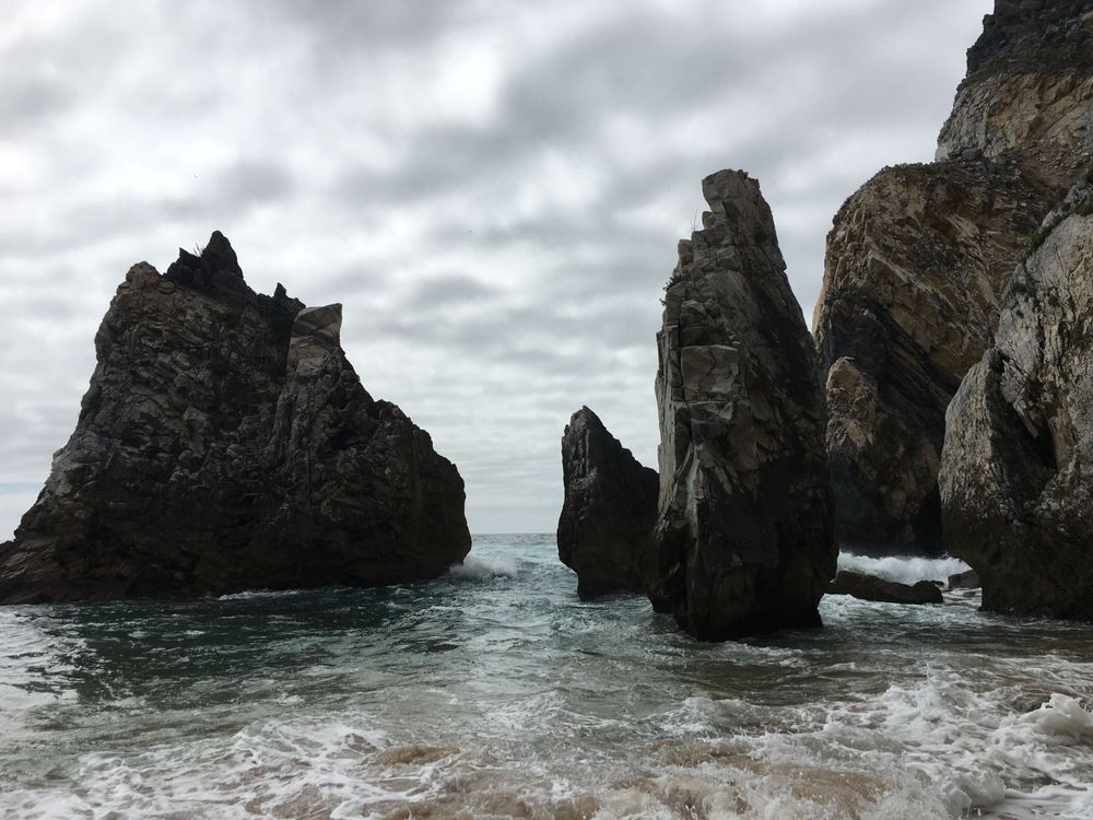 Sea and large rocks standing in the water.dramaic clounds.