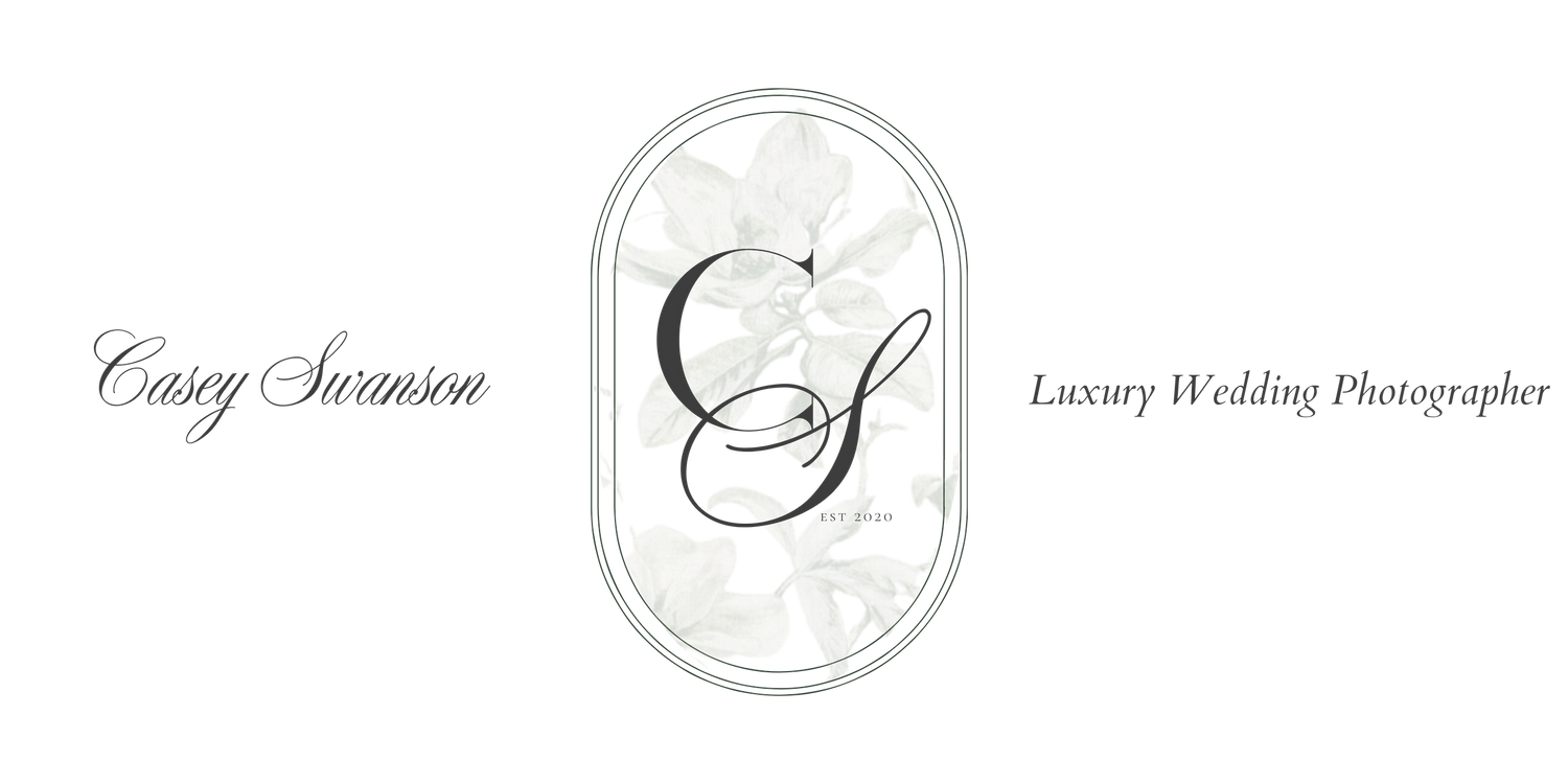 Vintage floral oval logo design with delicate white flowers against dark background.
