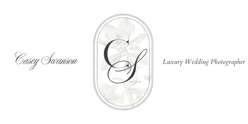 Vintage floral oval logo design with delicate white flowers against dark background.