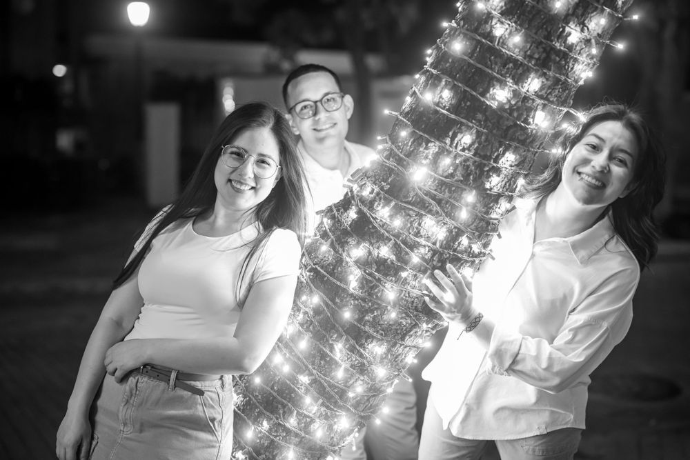 Black and white portrait with sparkling fairy lights creating a romantic atmosphere.