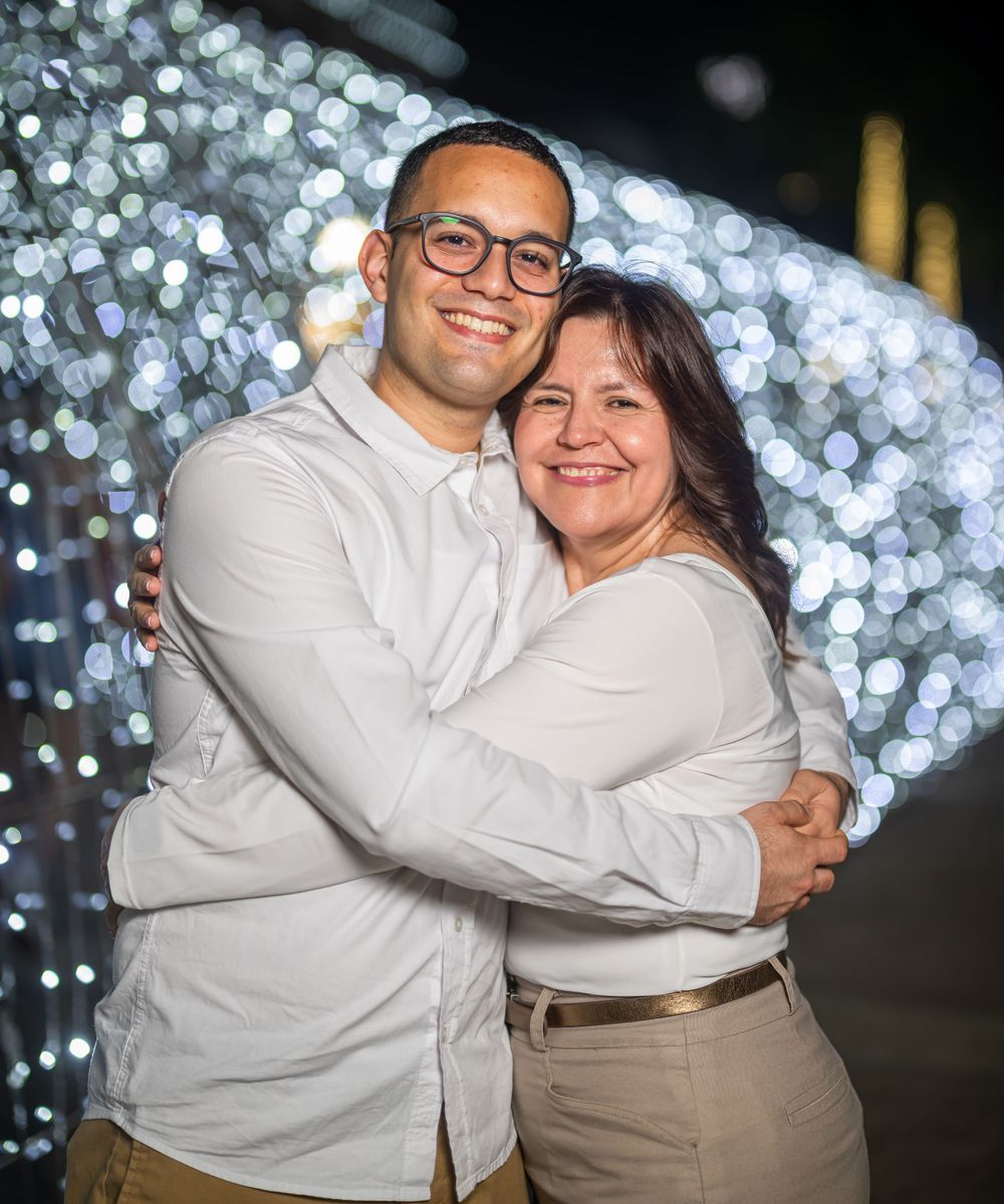 Loving embrace captured at night with beautiful bokeh light effects in the background.